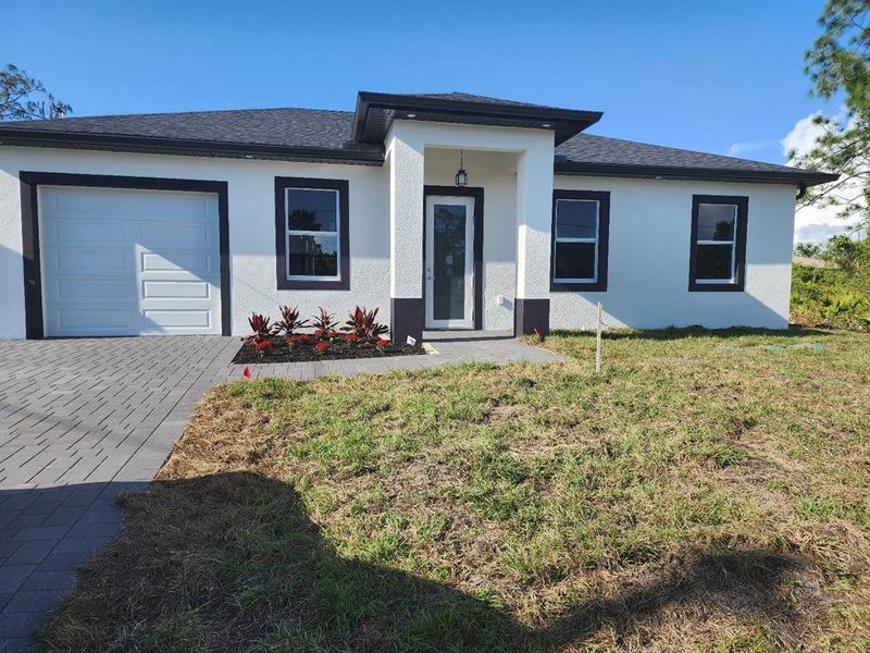 Front exterior of a new home in , Lehigh Acres, FL, highlighting curb appeal (Image 2).