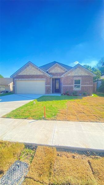 Ranch-style home with a garage and a front yard