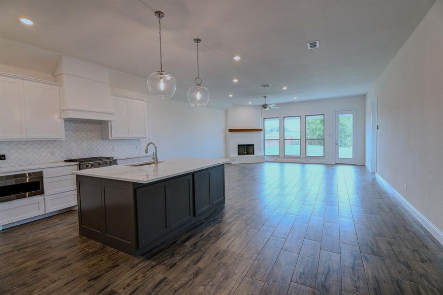Kitchen featuring a sink, ceiling fan, white cabinetry, dark wood-style flooring, and recessed lighting