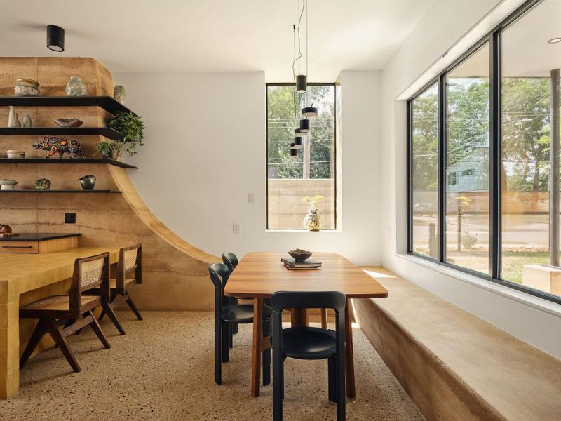 Dining room with plenty of natural light and polished concrete floors that have been honed to reveal a terrazzo-like finish Dining room with plenty of natural light and polished concrete floors that have been honed to reveal a terrazzo-like finish