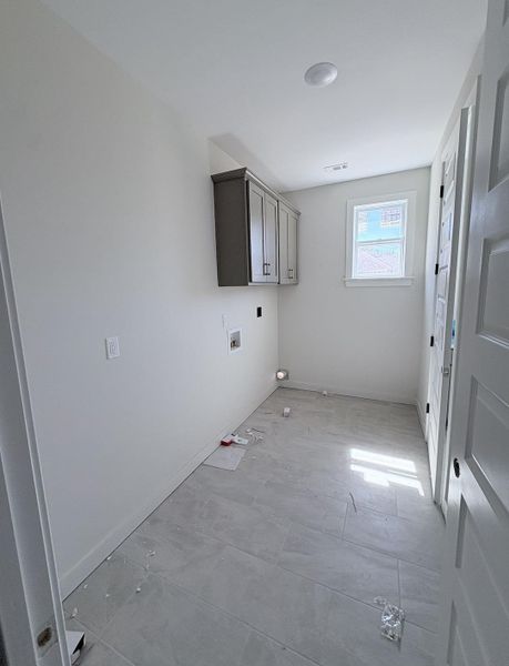 Built-in cabinetry, recessed lighting, window, and tile flooring Built-in cabinetry, recessed lighting, window, and tile flooring