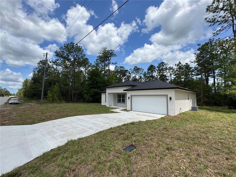 Front exterior of a new home in , Citrus Springs, FL, highlighting curb appeal (Image 1).