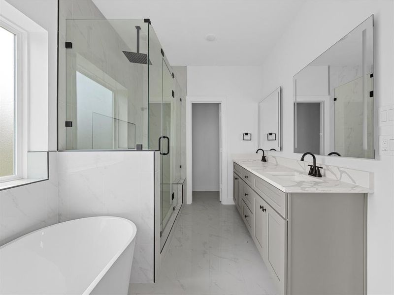 This modern bathroom features a sleek design with a spacious walk-in glass shower, a freestanding bathtub, and a double vanity with elegant marble countertops. Natural light streams in through a large window, enhancing the room's bright and airy feel.