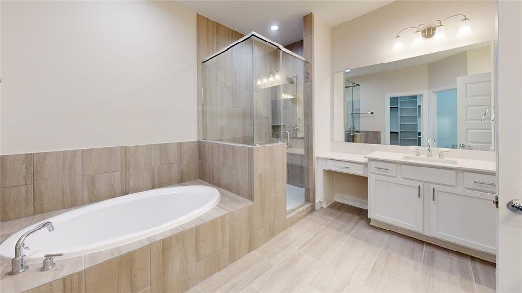 Step into a sanctuary of sleek sophistication with this luxurious bathroom, a symphony of modern design and comfort. Image depicts similar floor plan in another ROC Homes community.