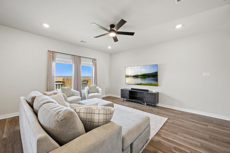 Rich wood flooring anchors this inviting space illuminated by clean recessed lighting. Rich wood flooring anchors this inviting space illuminated by clean recessed lighting.