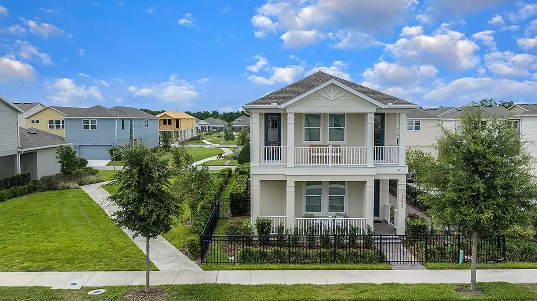 Front exterior of a new home in Harvest at Ovation, Winter Garden, FL, highlighting curb appeal (Image 2). Front exterior of a new home in Harvest at Ovation, Winter Garden, FL, highlighting curb appeal (Image 2).