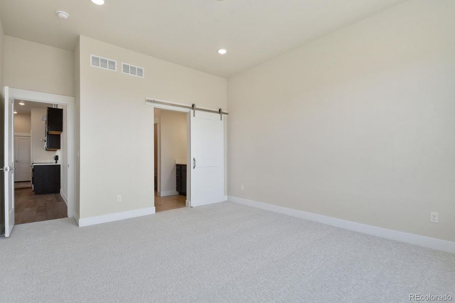 Primary Suite with en-suite bath, barn-door entrance.