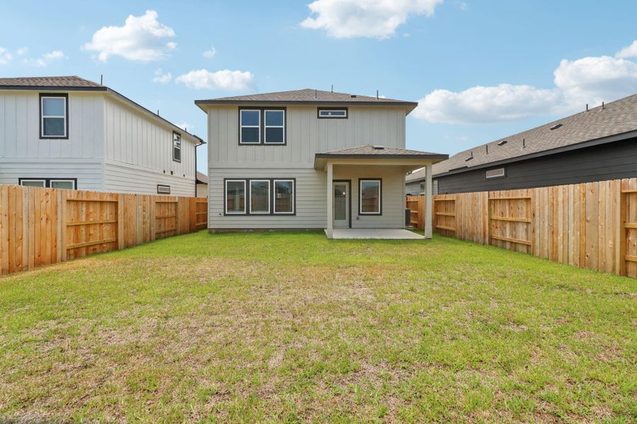 Front exterior of a new home in Mavera, Conroe, TX, highlighting curb appeal (Image 2).