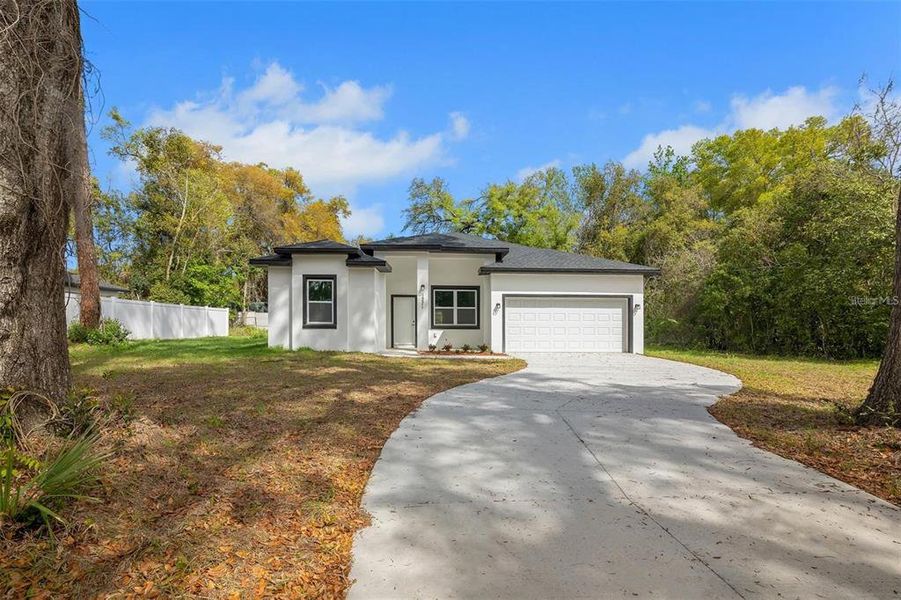 Front exterior of a new home in , Ocala, FL, highlighting curb appeal (Image 1). Front exterior of a new home in , Ocala, FL, highlighting curb appeal (Image 1).