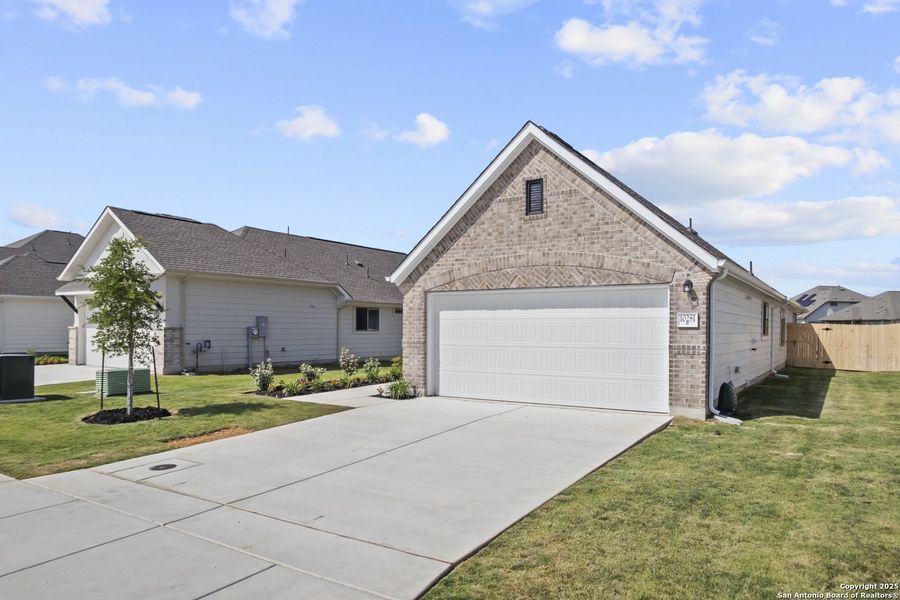 Front exterior of a new home in Rhine Valley, Schertz, TX, highlighting curb appeal (Image 15).
