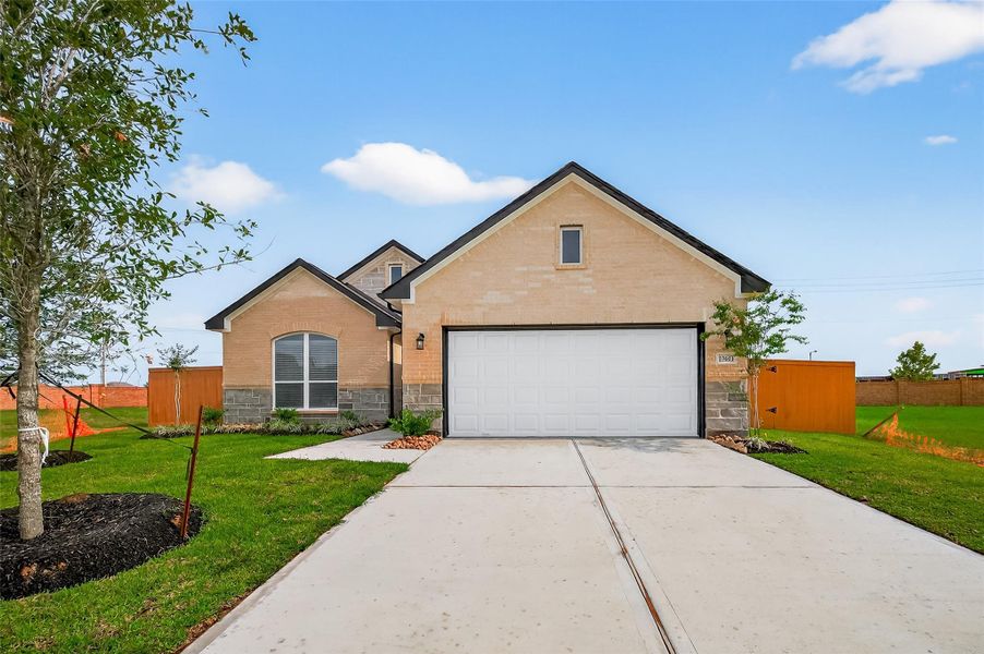Front exterior of a new home in Lago Mar, La Marque, TX, highlighting curb appeal (Image 2).