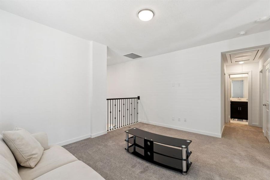 Sitting room featuring attic access and light carpet Sitting room featuring attic access and light carpet