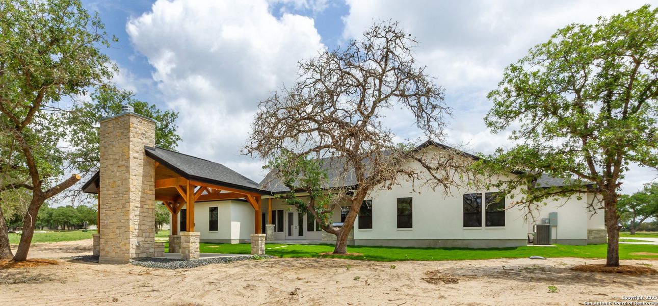 Front exterior of a new home in , La Vernia, TX, highlighting curb appeal (Image 26).