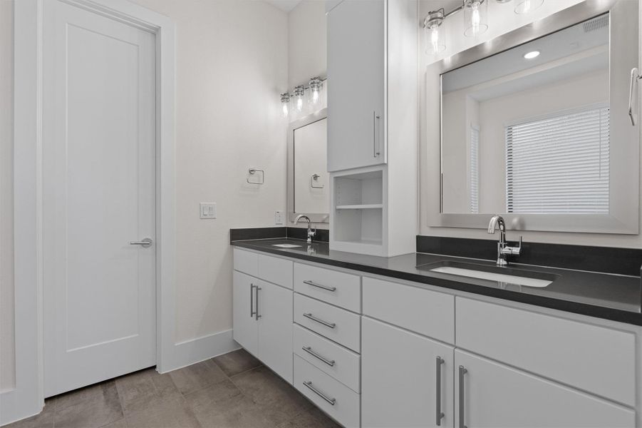 Bathroom with double vanity and light tile patterned floors Bathroom with double vanity and light tile patterned floors