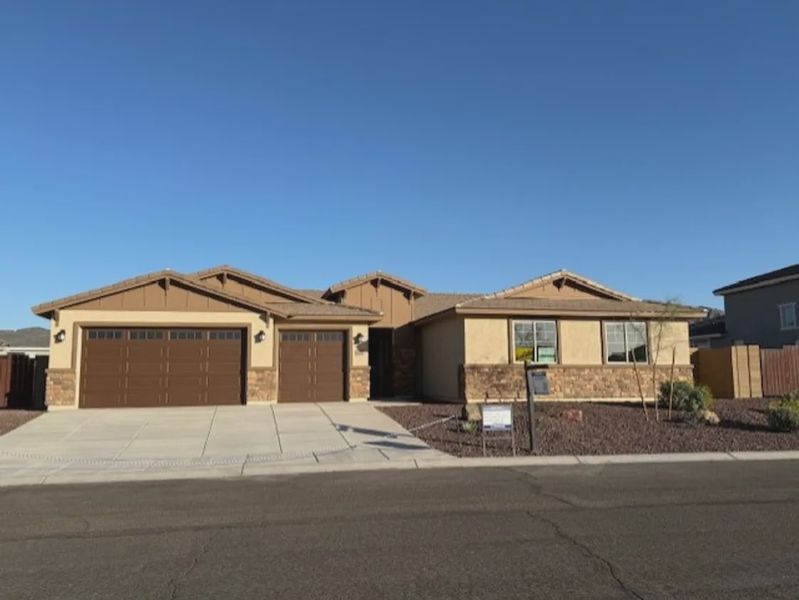 Front exterior of a new home in Las Barrancas, Yuma, AZ, highlighting curb appeal (Image 1). Front exterior of a new home in Las Barrancas, Yuma, AZ, highlighting curb appeal (Image 1).