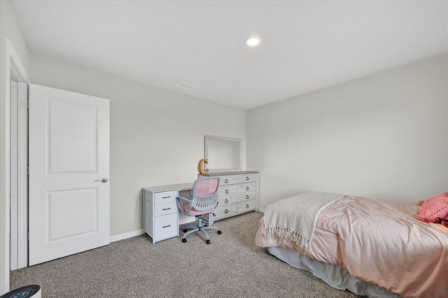 Bedroom featuring light colored carpet and baseboards