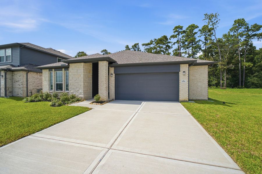 Front exterior of a new home in Sundance Cove, Crosby, TX, highlighting curb appeal (Image 26).