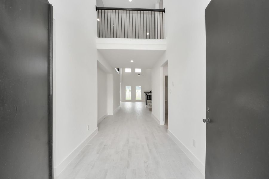 As you step into the threshold of this luxurious home, you'll soon be welcomed by an elegant glass door (to be installed). Inside, soaring ceilings amplify the spaciousness, while the refined wood-look tile flooring and oversized baseboards exude sophistication and charm. As you step into the threshold of this luxurious home, you'll soon be welcomed by an elegant glass door (to be installed). Inside, soaring ceilings amplify the spaciousness, while the refined wood-look tile flooring and oversized baseboards exude sophistication and charm.