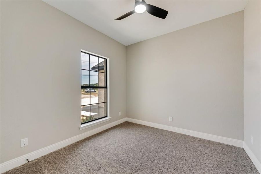 Unfurnished room featuring carpet flooring and ceiling fan