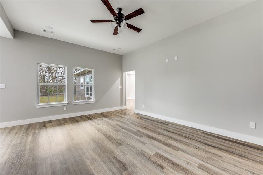 Unfurnished living room featuring a ceiling fan, recessed lighting, and light wood-type flooring