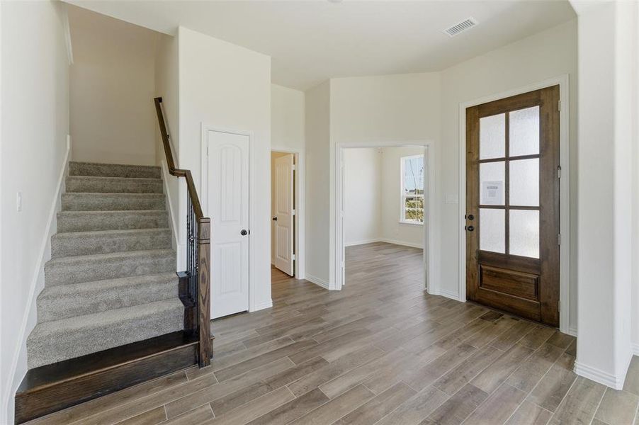 Entryway featuring stairs and light wood-style flooring Entryway featuring stairs and light wood-style flooring