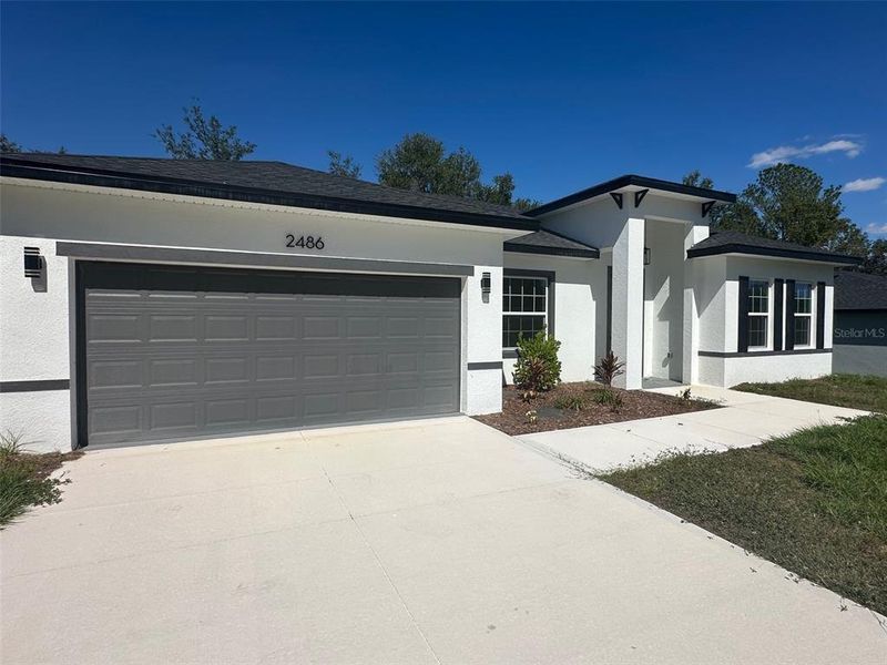 Front exterior of a new home in , Citrus Springs, FL, highlighting curb appeal (Image 25).