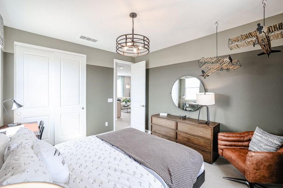 A bedroom with a bed and a mirror. A bedroom with a bed and a mirror.