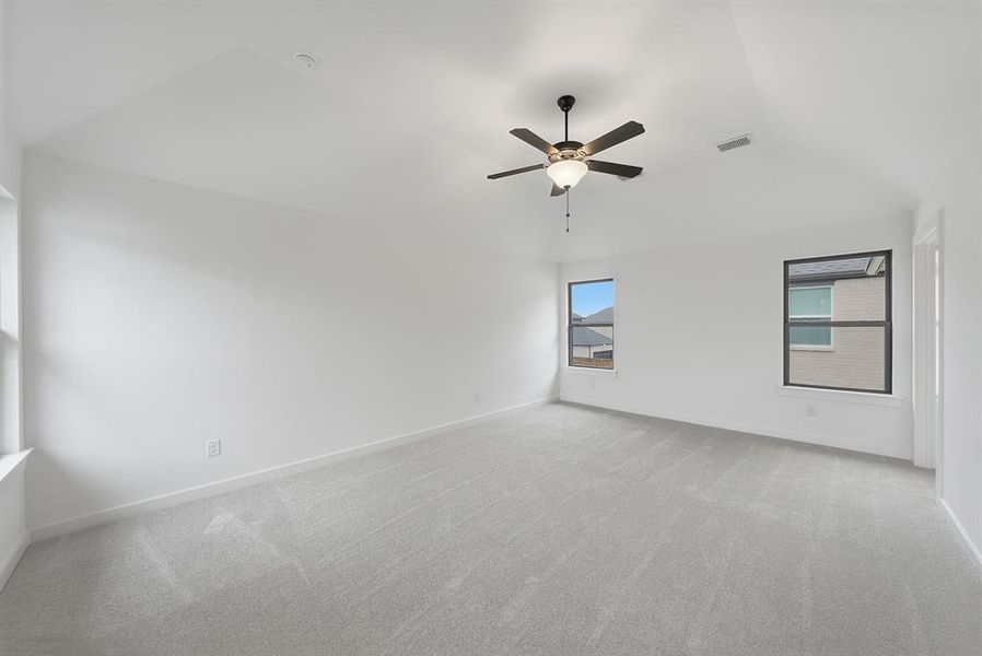Empty room featuring light carpet and a ceiling fan