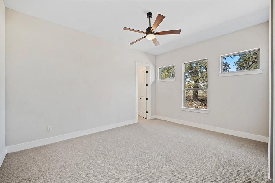 Unfurnished room featuring ceiling fan and light carpet Unfurnished room featuring ceiling fan and light carpet