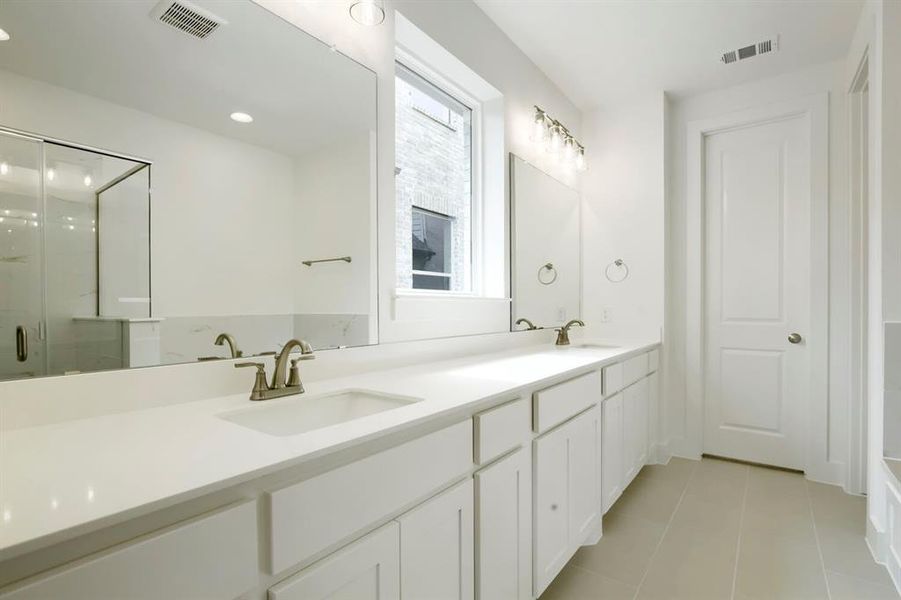 Double vanity with white cabinetry and integrated sinks