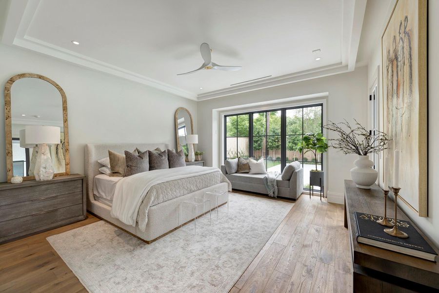 Primary suite enjoys backyard views and has a door opening to the covered patio (not shown).