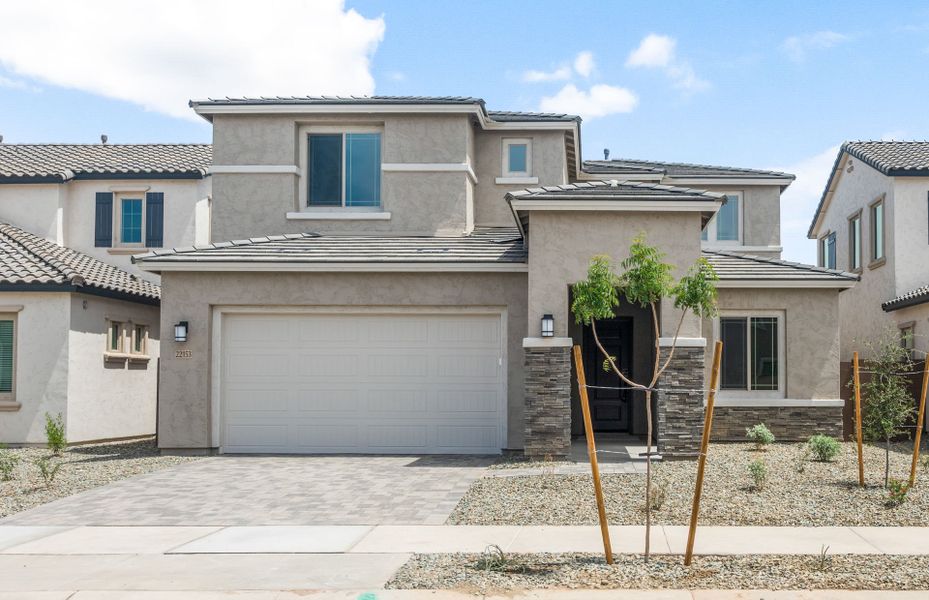 Front exterior of a new home in Legado West, Queen Creek, AZ, highlighting curb appeal (Image 2). Front exterior of a new home in Legado West, Queen Creek, AZ, highlighting curb appeal (Image 2).
