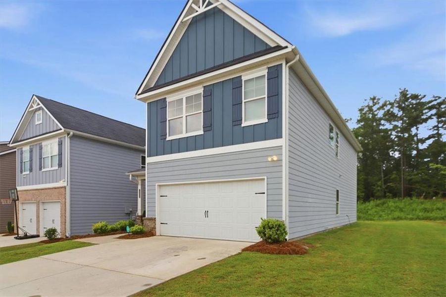 Front exterior of a new home in Fairview Lake, Conyers, GA, highlighting curb appeal (Image 24). Front exterior of a new home in Fairview Lake, Conyers, GA, highlighting curb appeal (Image 24).