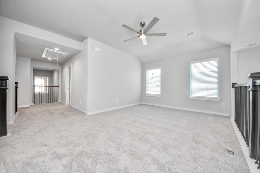 Ascend to relaxation in this fantastic game room! Ideal for both casual gatherings and adult gaming, it boasts plush carpet, lofty ceilings, custom paint, and ample windows for abundant natural light.