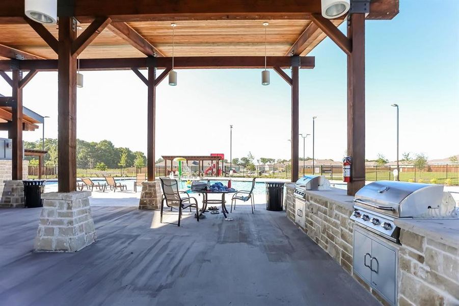 View of patio / terrace with a grill, area for grilling, and a community pool