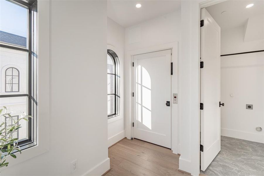 Foyer entrance featuring plenty of natural light and light wood-type flooring