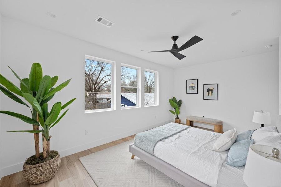 Bedroom featuring wood finished floors and a ceiling fan