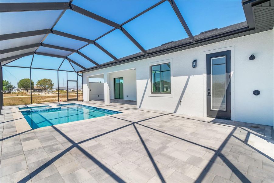 Swimming pool with hot tub, screened enclosure, and large Lanai area.