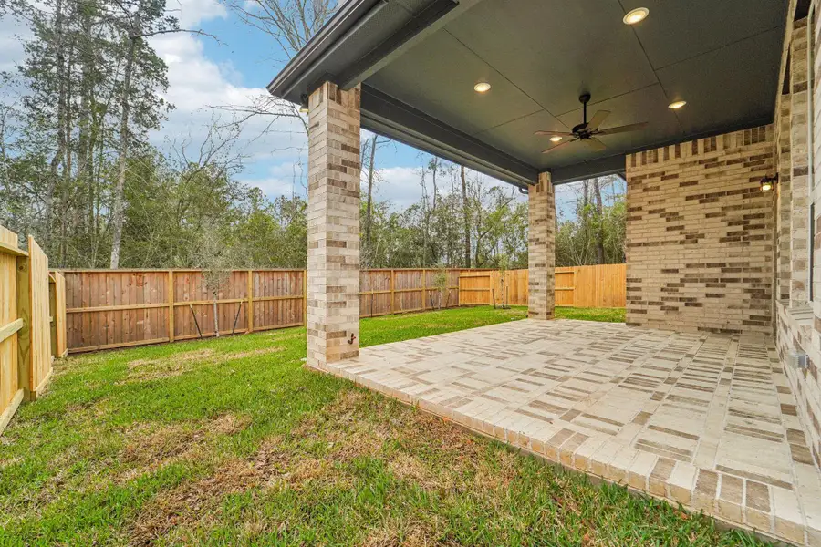 Exterior details and patio area of a home in The Woodlands Hills, Willis (Image 3).