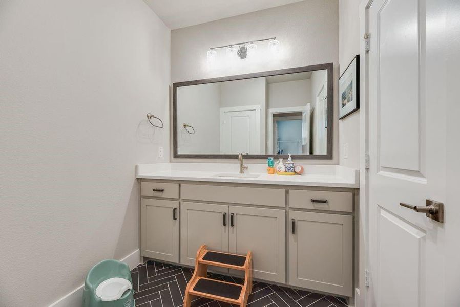 Bathroom with vanity and baseboards