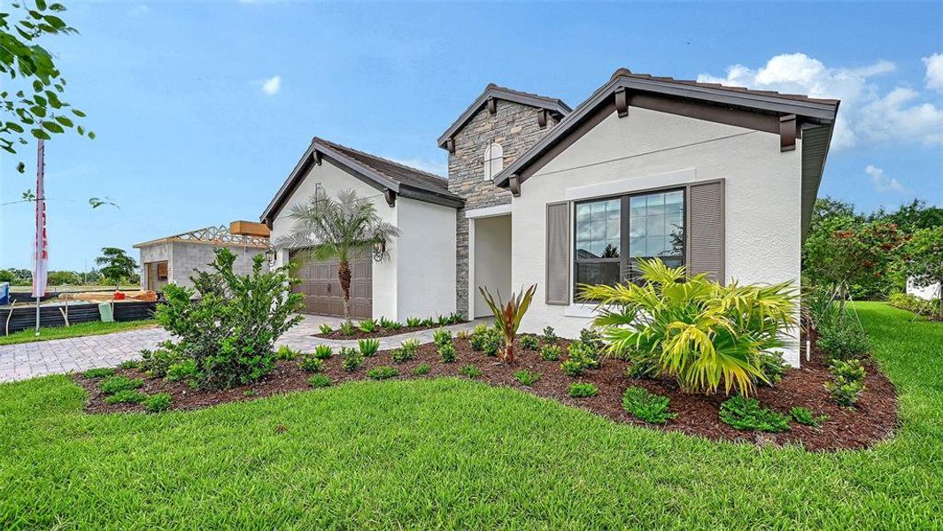Front exterior of a new home in Vistera of Venice, Nokomis, FL, highlighting curb appeal (Image 2).