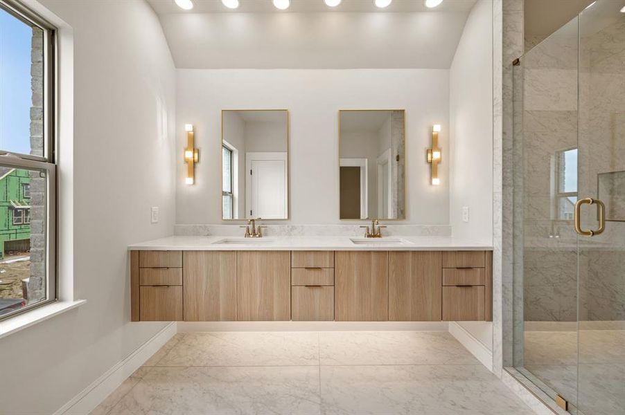 Featuring contemporary style and the perfect amount of space for two, this owner's bath is a dream come true!