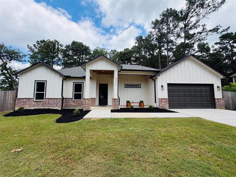 Front exterior of a new home in , Magnolia, TX, highlighting curb appeal (Image 2).