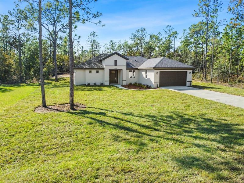 Front exterior of a new home in , Weeki Wachee, FL, highlighting curb appeal (Image 37). Front exterior of a new home in , Weeki Wachee, FL, highlighting curb appeal (Image 37).