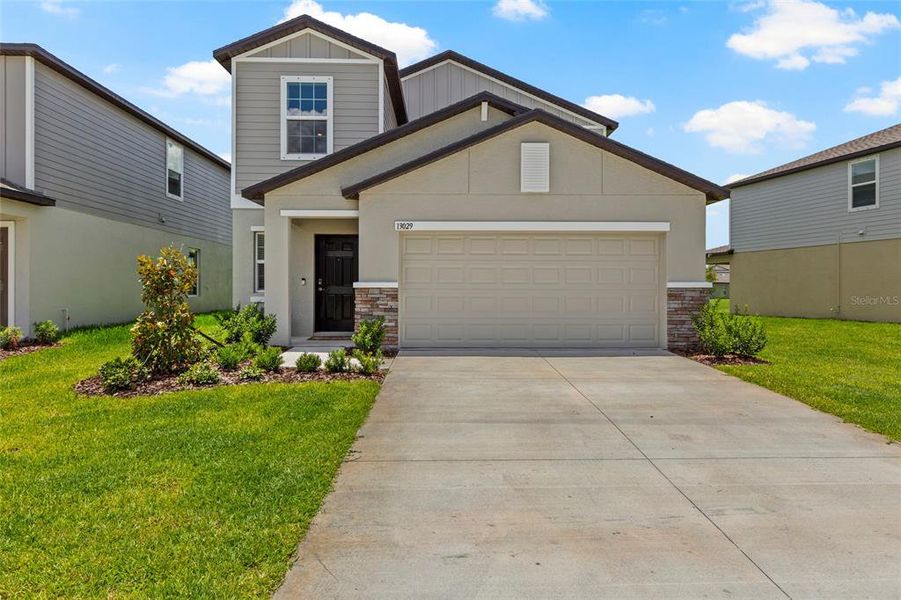 Front exterior of a new home in Prosperity Lakes, Parrish, FL, highlighting curb appeal (Image 30). Front exterior of a new home in Prosperity Lakes, Parrish, FL, highlighting curb appeal (Image 30).