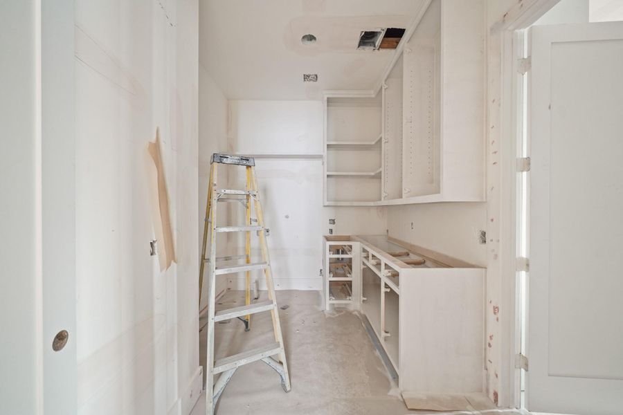 Centrally located upstairs is this massive laundry room!