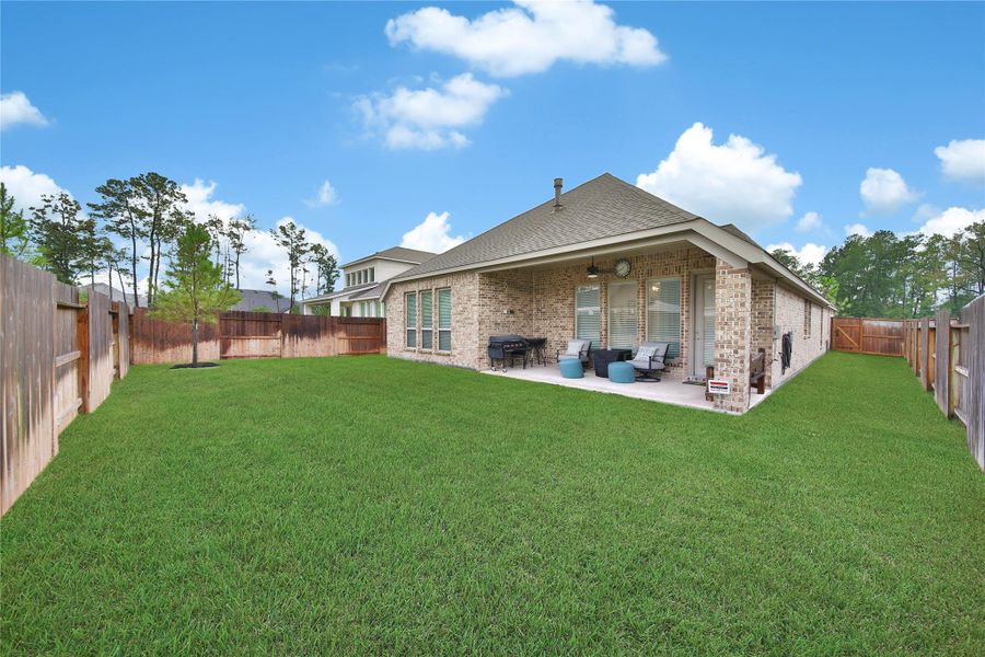 The fully irrigated backyard makes maintaining the lawn easier, leaving more time to enjoy the outdoor space.