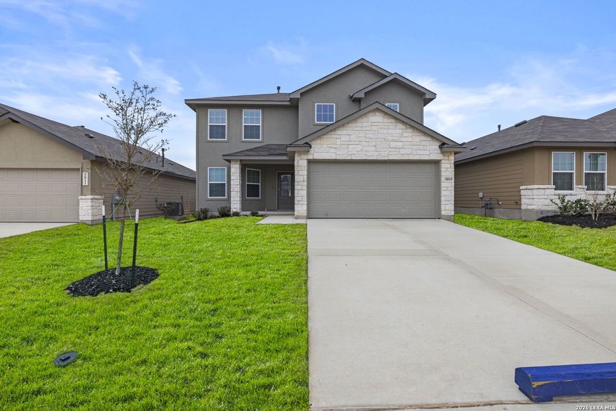 Front exterior of a new home in Avenida, Converse, TX, highlighting curb appeal (Image 1). Front exterior of a new home in Avenida, Converse, TX, highlighting curb appeal (Image 1).