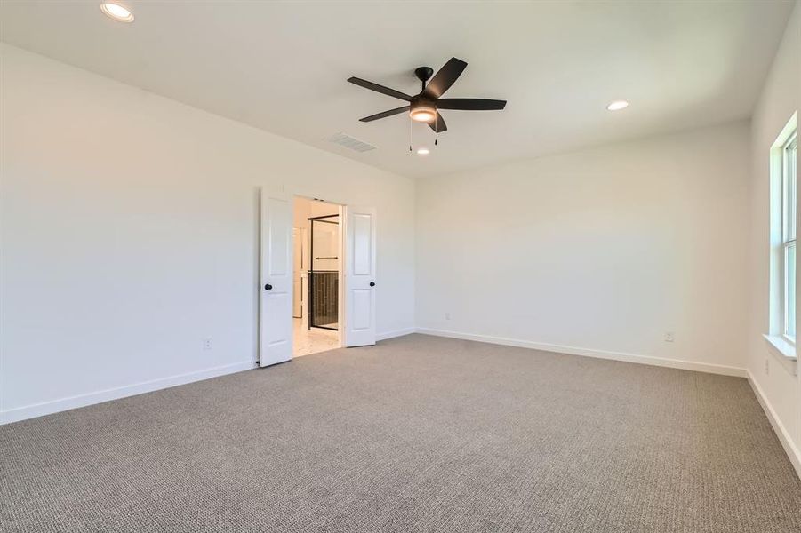 Empty room featuring carpet flooring, a ceiling fan, recessed lighting, and baseboards