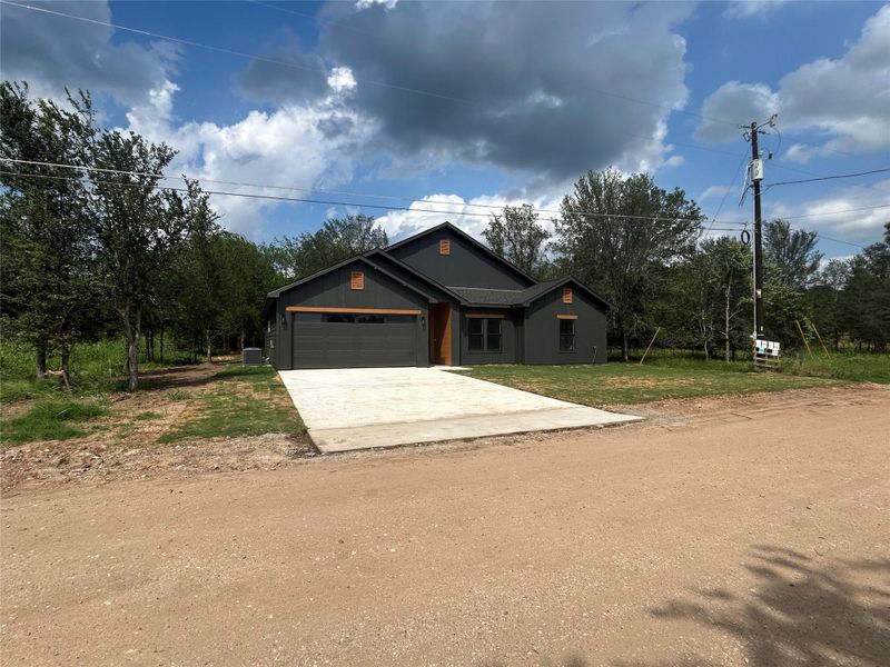 Front exterior of a new home in , Bastrop, TX, highlighting curb appeal (Image 19).